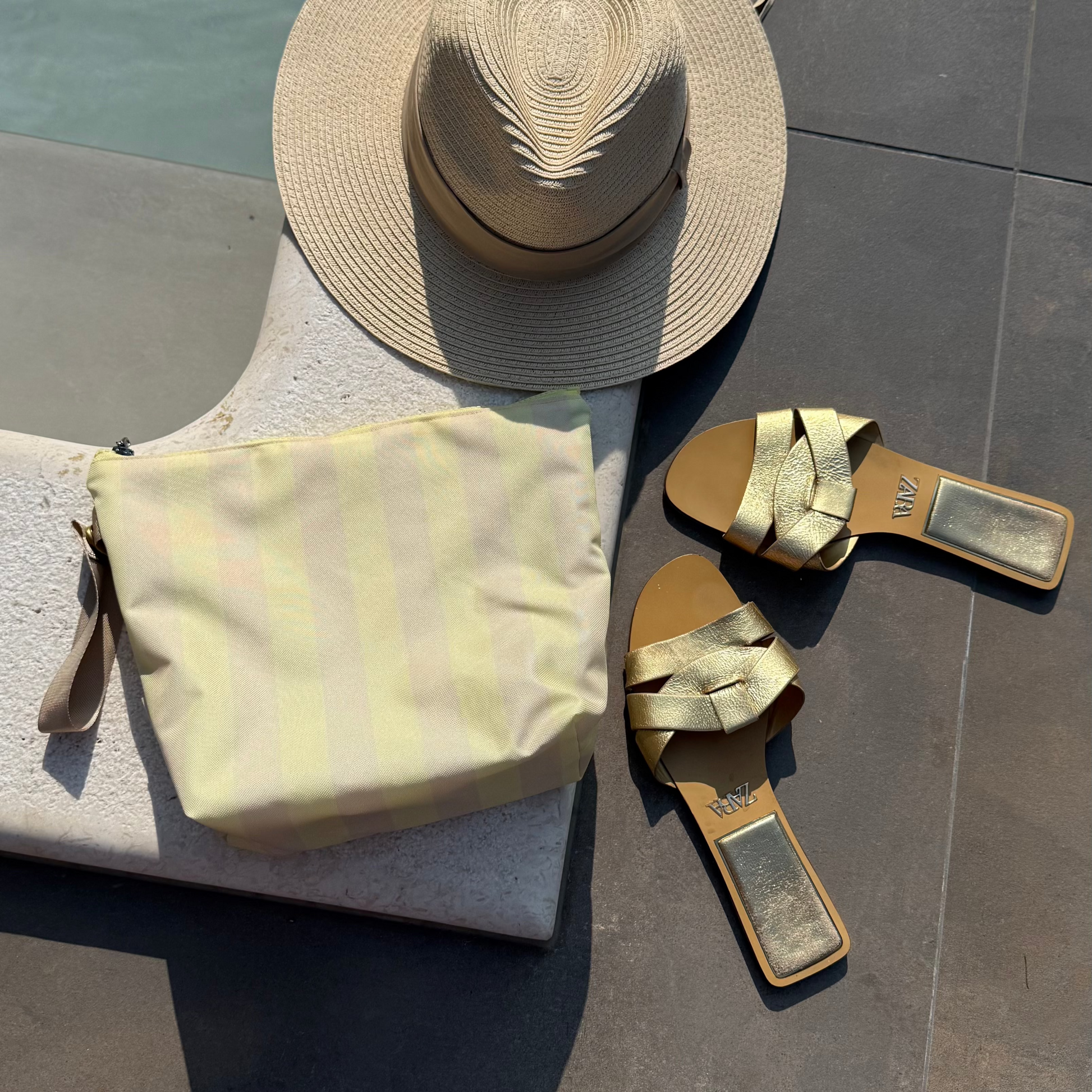 Aquabella Wetbag Butteryellow am Pool mit Sommerdeko, Sonnenbrille und Badeaccessoires